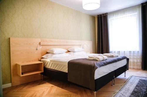 a bedroom with a bed with a large window at Dönhoff Residence in Pärnu