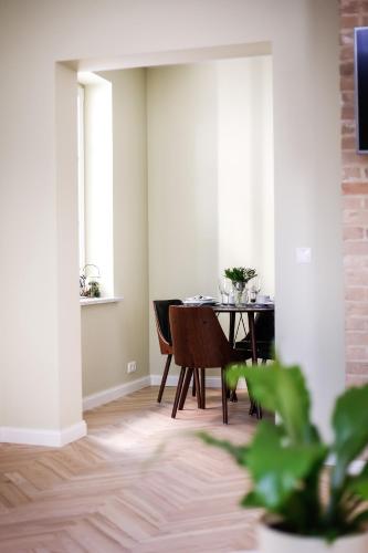 a dining room with a table and chairs at Dönhoff Residence in Pärnu