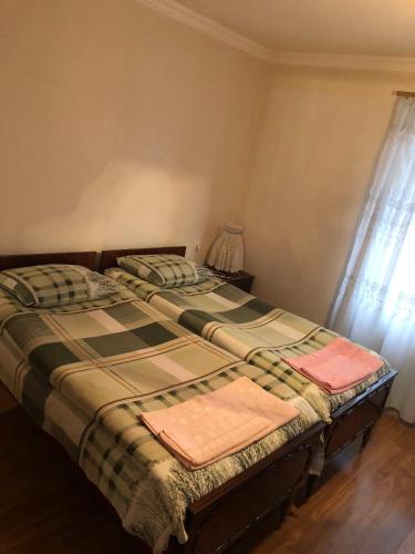 a bedroom with a bed with a blanket and a window at B&B Odzun in Odzun