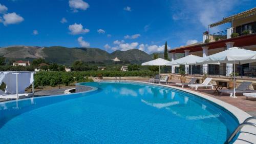a pool at a hotel with mountains in the background at Aneli Luxury Villas-Villa Anastasia in Ayios Kirikos