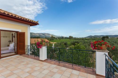 a bedroom villa with a balcony with a view at Aneli Luxury Villas-Villa Anastasia in Ayios Kirikos