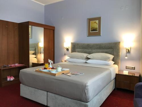 a bedroom with a large bed with a tray on it at Art 'Otel in Sofia