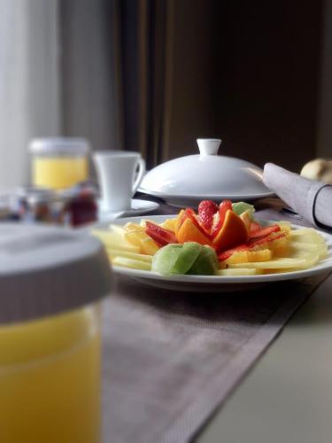 a plate of fruit on top of a table at Escalus Luxury Suites Verona in Verona