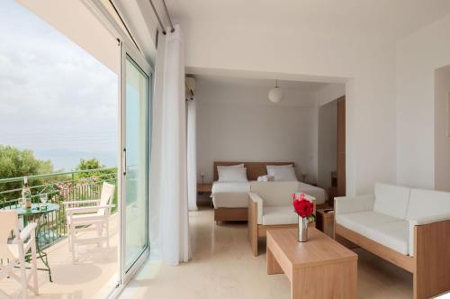 a living room with a couch and a table at Studios Angeliki in Lassi