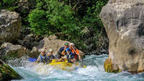 a group of people on a raft in a river at Garden Hotel Pasanauri since 1892 in Passanauri