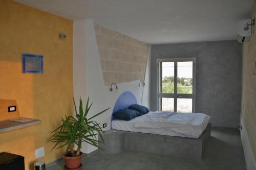 - une chambre avec un lit et une fenêtre dans l'établissement Vacanze in Puglia, à San Pietro in Bevagna