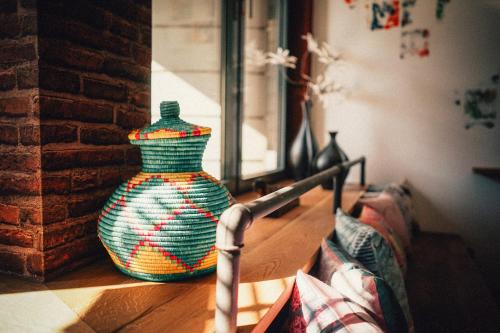 a colorful vase sitting on a table in a room at 36 Phô Cô Hotel & Suites in Weimar