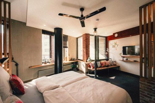 a bedroom with a bed and a television in it at 36 Phô Cô Hotel & Suites in Weimar