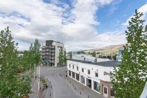 a view of a street in a city with buildings at Acco Town Square Apartments in Akureyri