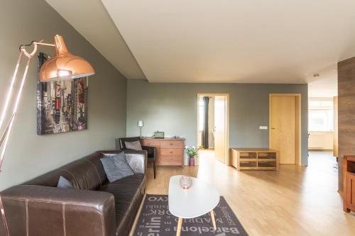 a living room with a couch and a table at Acco Town Square Apartments in Akureyri