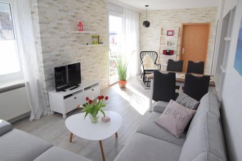 a living room with a couch and a table at Hotel Thode in Dahme