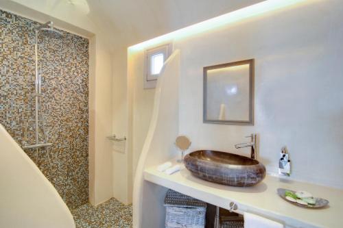 a bathroom with a wooden sink and a shower at Santorini Secret Premium in Oia