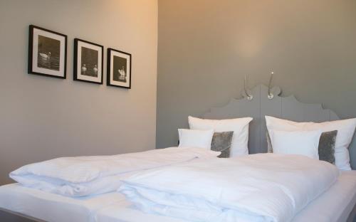 a bedroom with a bed with white sheets and pillows at Hotel Restaurant zur Marienburg in Pünderich