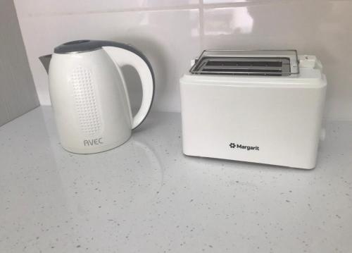 a toaster and a toaster sitting on a counter at Modern Apartment in Pafos Near the Sea in Paphos