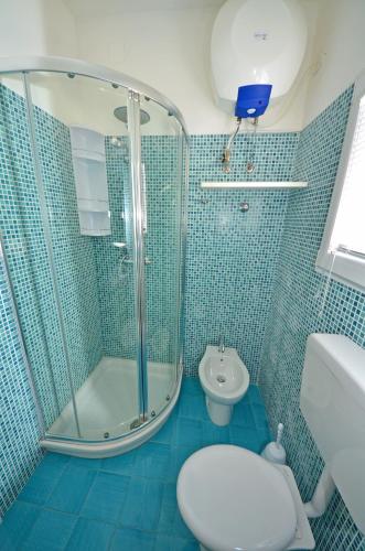 a bathroom with a shower and a toilet and a sink at Casa Baia smeraldo in Leuca