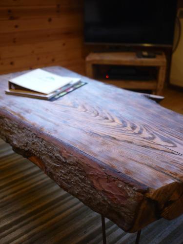 a wooden table with a book on top of it at Dulnain in Aviemore