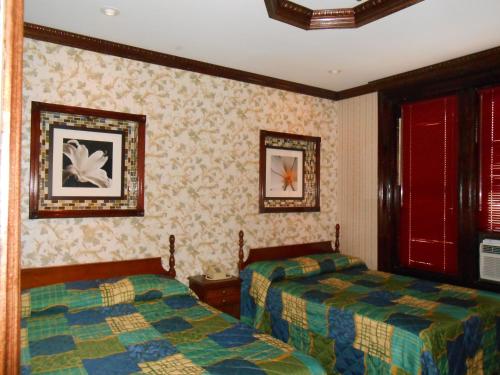 a hotel room with two beds and two windows at Hotel 31 Extended Stay in New York