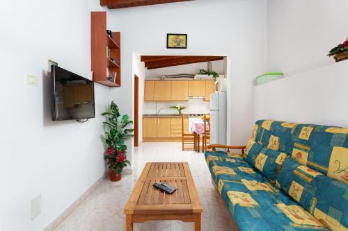 a living room with a couch and a table at Finca La Gaviota - El Rincon in Icod de los Vinos