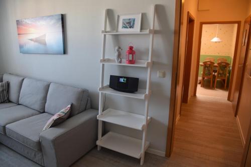 a living room with a couch and a book shelf at Hotel Thode in Dahme