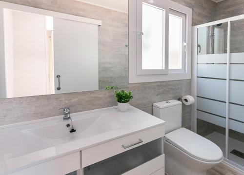 a bathroom with a white sink and a toilet at Camping Villasol in Benidorm