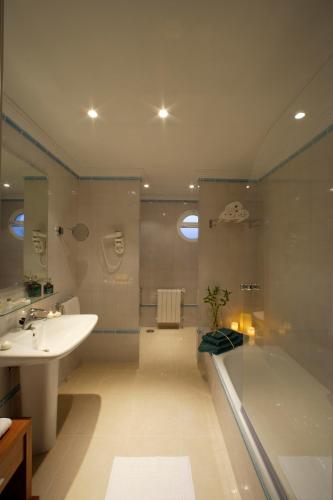 a bathroom with a tub and a sink and a shower at Apartamentos Marina Turquesa in Nerja