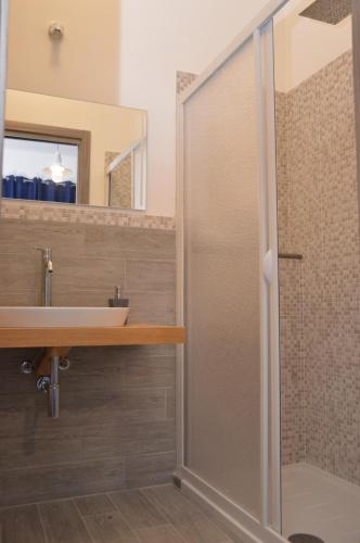 a bathroom with a shower and a sink at Rais in San Vito lo Capo