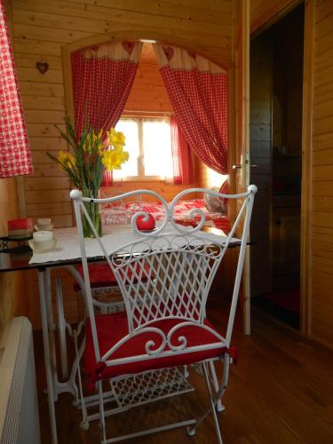 a red and white chair at a table in a room at La Canfouine in Lamballe