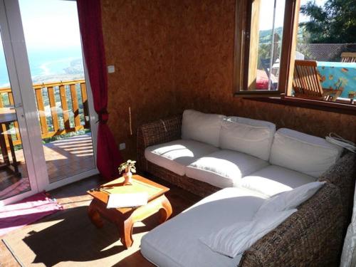 a living room with a couch and a table at Les bungalows de la kazouale in Saint-Leu