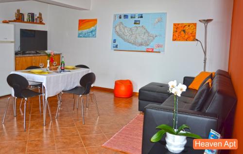 a living room with a table and a couch at Villa Henriques in Funchal