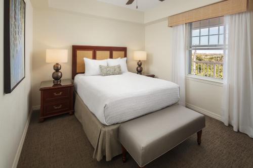 a white bedroom with a bed and a window at Hyatt Vacation Club at Windward Pointe in Key West