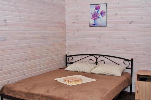 a small bedroom with a bed with a wooden wall at Veranda in Karolino-Buhaz