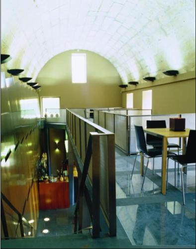 an office with a staircase and a table and chairs at Pousada de Angra do Heroismo Castelo de S. Sebastiao in Angra do Heroísmo