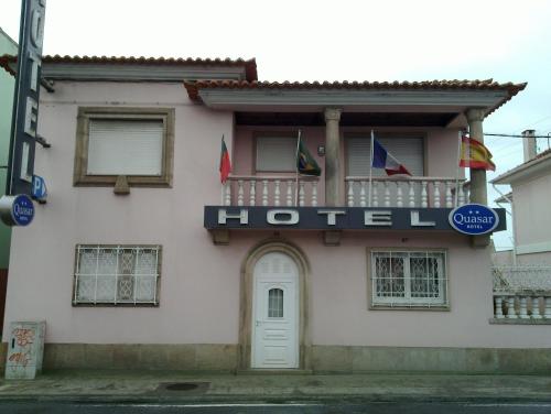 a hotel with flags on the front of a building at Hotel Quasar in Porto