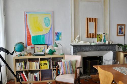 a living room with a book shelf filled with books at L'Enclos in Lorgues
