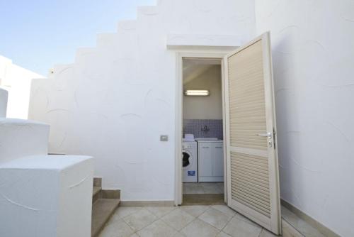 a hallway with a door leading to a kitchen at Blue Sea Villas by Wonderful Italy in Ostuni