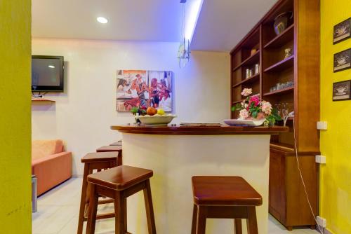a bar in a room with stools and a tv at Villa Jadranka Sutomore in Sutomore