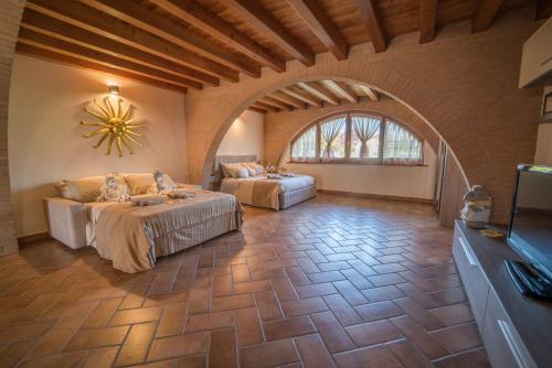 a large room with two beds and a flat screen tv at B&B la Serenissima in Fossalta di Portogruaro