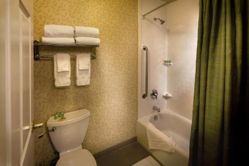 a bathroom with a toilet and a shower with towels at Granzella's Inn in Williams