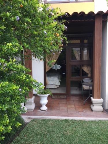 a front door of a house with two vases on a patio at Hostal Villa Toscana in Guatemala