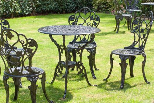 a group of tables and chairs sitting in the grass at Ascot House in Harrogate