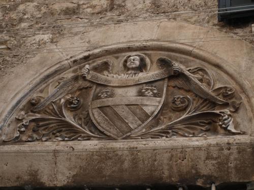 a stone building with a crest on the side of it at Guesthouse Vicelic in Dubrovnik