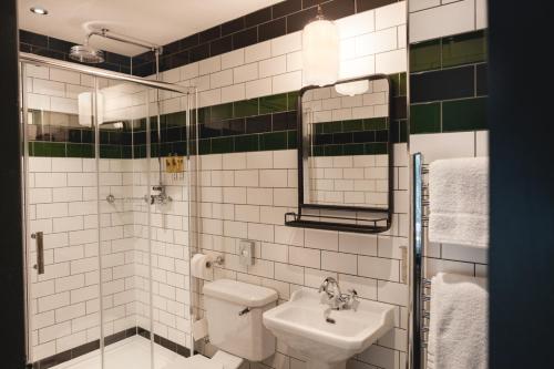 a bathroom with a sink and a mirror at Pontcanna Inn in Cardiff