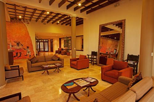 a large living room with couches and a table at La Hacienda Bahia Paracas in Paracas