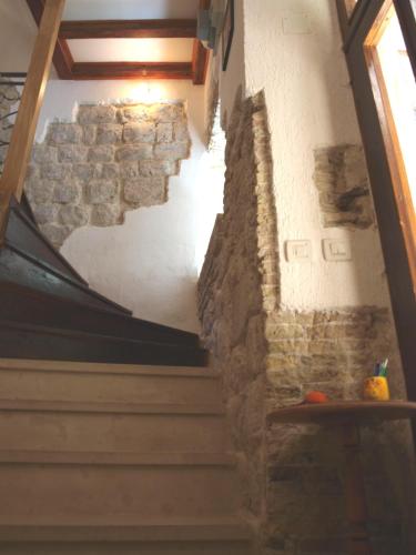 a staircase in a building with a stone wall at Guesthouse Vicelic in Dubrovnik