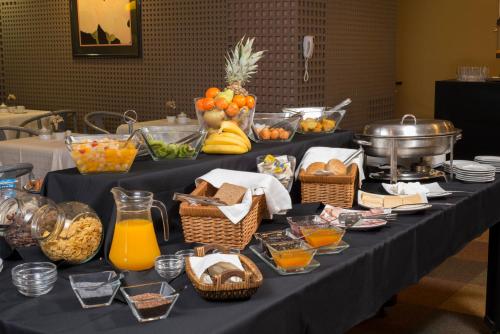 a table with a bunch of food on it at Hotel Alborada in Concepción