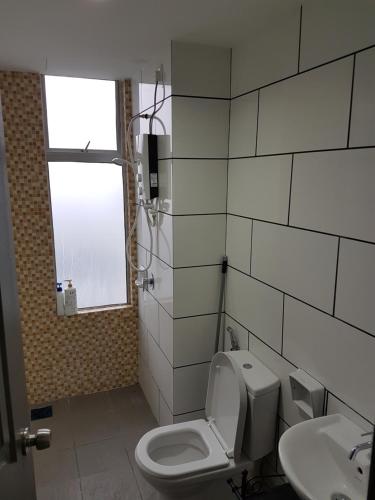 a bathroom with a toilet and a sink at Taiping Centre Point Suite 7 by BWC in Taiping