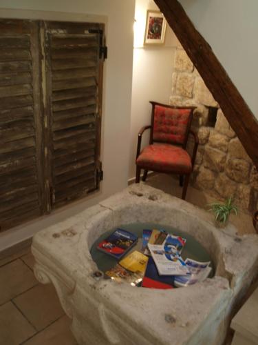 a living room with a chair and a dog bowl at Guesthouse Vicelic in Dubrovnik