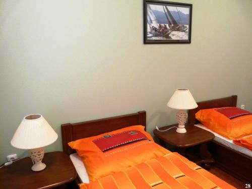 a bedroom with two beds and two lamps on tables at Resort Maják in Horní Soběšovice