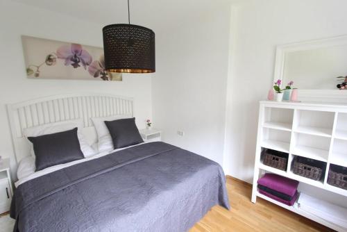 ein Schlafzimmer mit einem Bett und einem weißen Regal in der Unterkunft Haus Anneliese in Bad Reichenhall