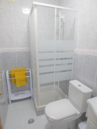 a white bathroom with a shower and a toilet at D WAN 4 | Baleal in Ferrel